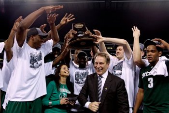 Michigan State players crowd around Tom and Lupe Izzo and hold up the Midwest Regional Championship trophy (Photo from: ESPN.com)